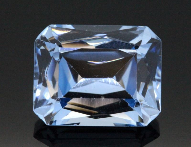 LOOSE EMERALD CUT CHATHAM BLUE SPINEL 9.56 CARATS: Weighing 9.56 carats, measuring 13.2 x 10.6 x 6.82mm, medium deep blue Chatham lab spinel. Tiny scuff on facet lines, invisible to naked eye. This lot has a reserve.