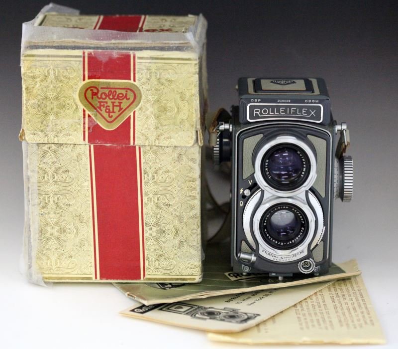 VINTAGE ROLLEIFLEX 4X4 MOVIE CAMERA WITH BOX: Vintage Rolleiflex 4 x 4, gray body, with a Heidosmat f/2.8 60mm viewing lens and a Schneider Xenar f/3.5 60mm taking lens no. 5476907, in matching ever ready case, with original box, guarantee certif