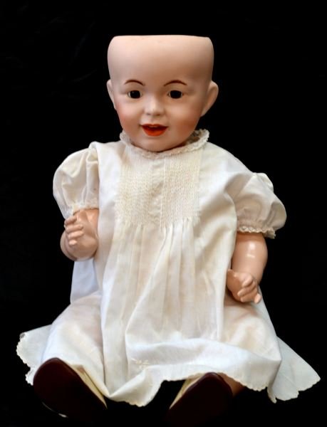 FRENCH ANTIQUE BISQUE HEAD DOLL SFBJ 236 PARIS 12: French antique bisque doll with composition body, circa early 1900's. Marked "S.F.B.J. 236 Paris 12" on back of head. Measures 20 inches long. Dressed in old white dress and shoes. No hair. Minor surf