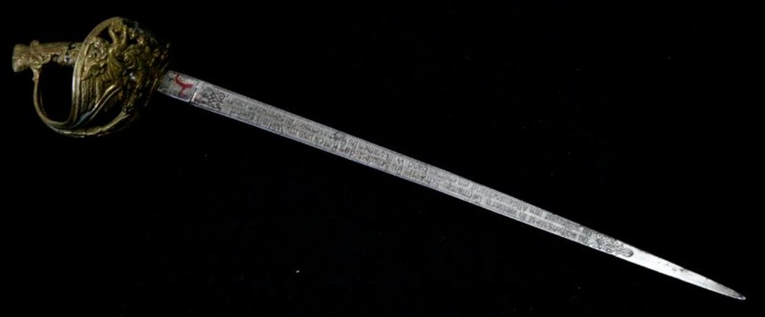 GERMAN GILT HANDLE ENGRAVED STEEL LETTER OPENER: German brass and steel engraved letter opener, World War II. Open work gilt guard with angel holding crown design. Engraved blade with patriotic German message. Measures 11 inches. Very good condition