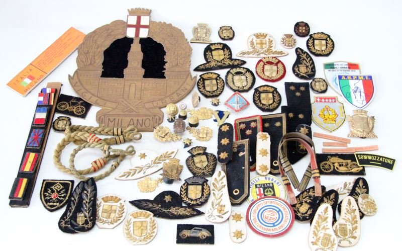 MILAN ITALY ANTIQUE POLICE BULLION INSIGNIA: Grouping of bullion insignia to include, cyclist, motorcycle, automobile, high ranking collar insignia, Commandant shoulder straps and hat bullion, shoulder and cap badges, paper cut out of the Urban