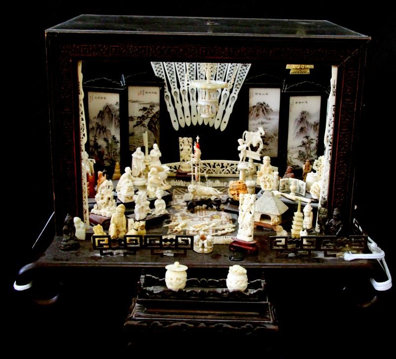 ASIAN DEITY NETSUKE MINI FIGURINES CARVED IVORY: Hand-crafted shrine of carved Ivory and wood mini figurines / netsukes. Chinese, Japanese, Thai and Indian influence. Some deities and/or characters depicted: Sarawasti, Mararisay (Thai Buddha), other