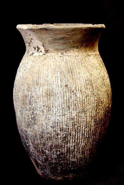 GREY ORIENTAL VASE WITH VERTICAL RIBBING: Possibly Han Dynasty (206 BC TO 220 AD) The vase is decorated with vertical ribbing. The item is approximately 7.25 inches tall, 4 inch rim diameter, and approximately 5 inches at its widest point. Ha