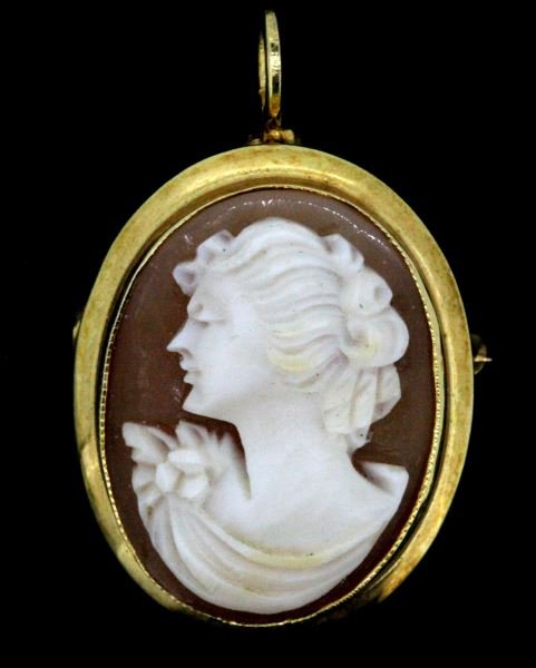 VINTAGE LADIES 10KT YG SHELL CAMEO PENDANT/BROOCH: Circa 1930-40's, 23 x 18mm, oval shape shell cameo, high polish bezel, scalloped edging on bezel close to cameo. "C" clasp with tab slide, plus hinged pendant bail. This lot has a reserve
