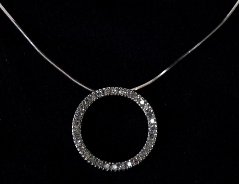 LADIES 14KT WHITE GOLD DIAMOND CIRCLE PENDANT: Nice style for everyday enjoyment; 18mm in diameter round pendant setting containing 32 round full cut white clean diamonds, with approximate total diamond weight of just under 1/2 ct. tw. This lot ha