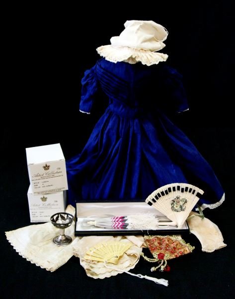 VINTAGE 19 INCH DOLL CLOTHING WIGS ETC.: Included is a full length blue dress (16 inches long), an outfit with a full length skirt in green, a waist coat top and matching bonnet. There is a maroon outfit including skirt, velour jacket, hat a