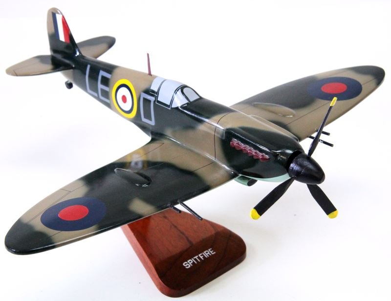 WWII SUPERMARINE SPITFIRE WOODEN 1/32 DESK MODEL: 18.5 inch wingspan and 16 inches tip to tail. In very good condition with some minor issues. Prop is slightly out of alignment and one blade needs reglued. Some paint cracks along joins. Handmade in t