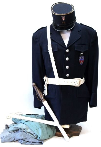 FRENCH PARISIAN PREFECTURE DE POLICE UNIFORM: Vintage Prefecture de Police uniform. Includes tunic, trousers, four shirts, two ties, Kepi, two batons, and a belt with a holster and baton attachment. The uniform is free from mothing. The coat has
