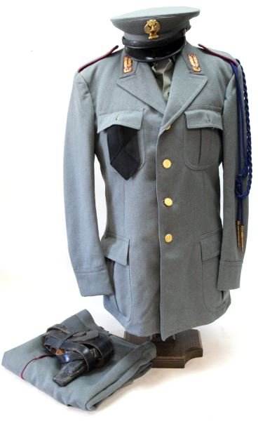 POST WWII ITALIAN GUARD OF PUBLIC SAFETY UNIFORM: Post war Italian uniform with tunic, shirt, trousers, tie, replacement shirt cuffs, aiguillette, cap, and belt with holster. The tunic comes with a complete set of buttons with emblems, and enamel col