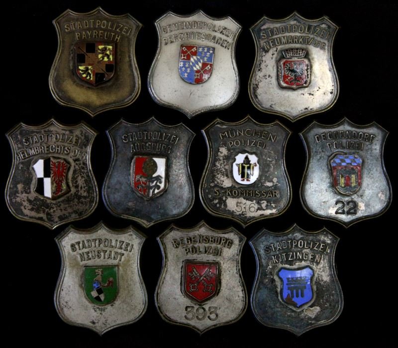 VINTAGE GERMAN POLICE BADGE LOT OF 10 FULL SIZE: Ten different badges, including a numbered Commissioner Munich 516, Regensburg is also numbered 393, all 2 3/4 inch pin back shields, from the World police Museum, Milan, Italy and are accompanied wit