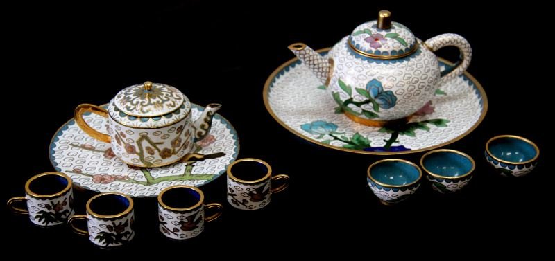 VINTAGE CLOISONNE DOLL MINIATURE TEA SET LOT OF 2: Cloisonne tea sets. One has 3 cups, one has 4 cups with handles, both have trays. Bird and floral motifs. Very good condition. 0