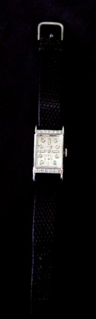 VINTAGE MENS 14KT WG LONGINES WATCH W/DIAMONDS: Manufactured by Longines-Wittenaur in 1947, solid 14kt white gold tank style case and back. "Curvex" case design adorned with 12 round single cut diamonds, each weighing approximately .03cts.,two rows