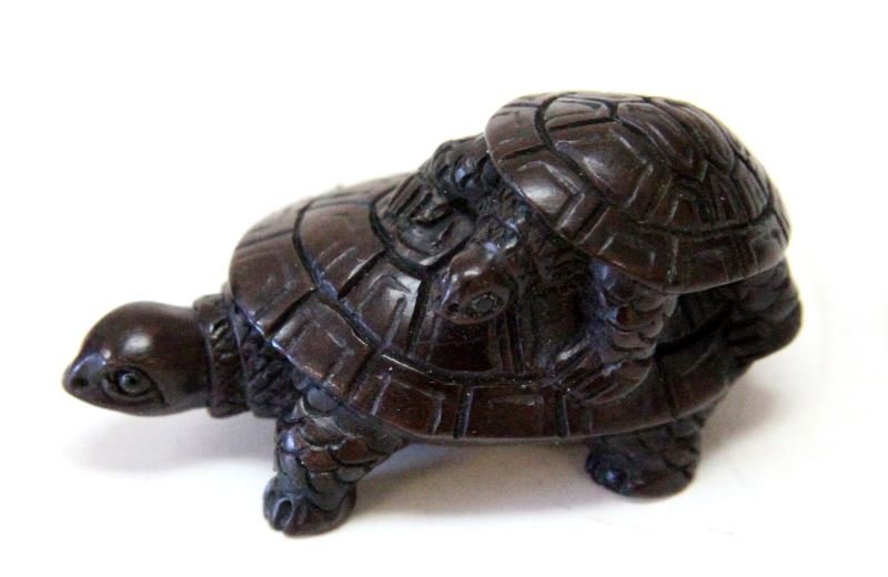 TWO TURLES ANTIQUE JAPANESE WOOD NETSUKE SIGNED: A small turtle on top of a larger turtle, these turtle are carved with great attention to detail and have beaded eyes. In very good condition. 2.5 inches long. Signed on ivory disc inset. 0
