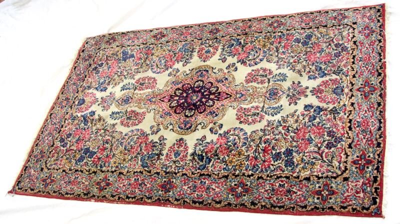 SEMI ANTIQUE HAND KNOTTED TURKISH SILK CARPET: Bright floral designs adorn this silk carpet. Short tassels and bound edge. 36 by 59 inches. Natural dyes. Some wear to edge. Appears to be a Hereke. Overall very good bright condition. 0