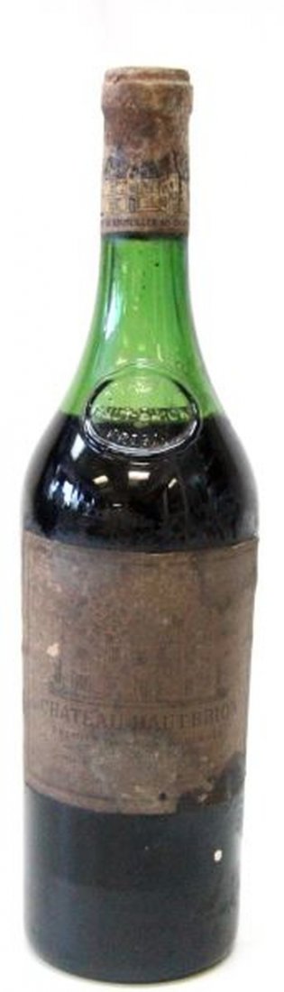 VINTAGE CHATEAU HAUT-BRION BORDEAUX BOTTLE OF WINE: 1970 Chateau Haut-Brion Bordeaux sealed wine bottle. The ullage for this bottle of wine is in the top shoulder, which is excellent for a wine of this age. The label has some stains,and has begun to fa