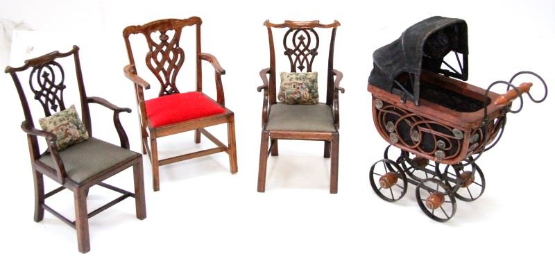 VINTAGE DOLL HOUSE CHAIRS AND STROLLER: Lot of three chairs and one baby carriage. The chairs are Chippendale style chairs, two are matching and include cushions. The third chair is slightly wider and shorter. The stroller is an antique sty