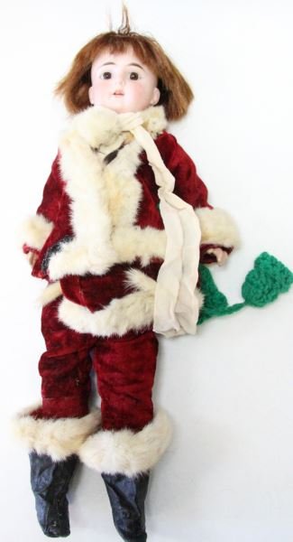 CUNO & OTTO DRESSEL CHRISTMAS DOLL 18 INCHES TALL: Cuno & Otto Dressel doll marked "COD 3" behind hair. The doll has a bisque head and composition body. She is dressed in a Santa Claus costume, which includes the hat and boots. She appears to be in ov