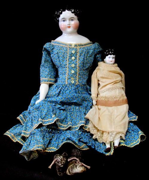 2 ANTIQUE CHINA DOLLS 19TH 20TH CENTURY 20 INCHES: China dolls from the 19th century to early 20th century. One has a porcelain head and arms. Her hair and features are painted on, some of the black paint on hair has come off. She is dressed and weari