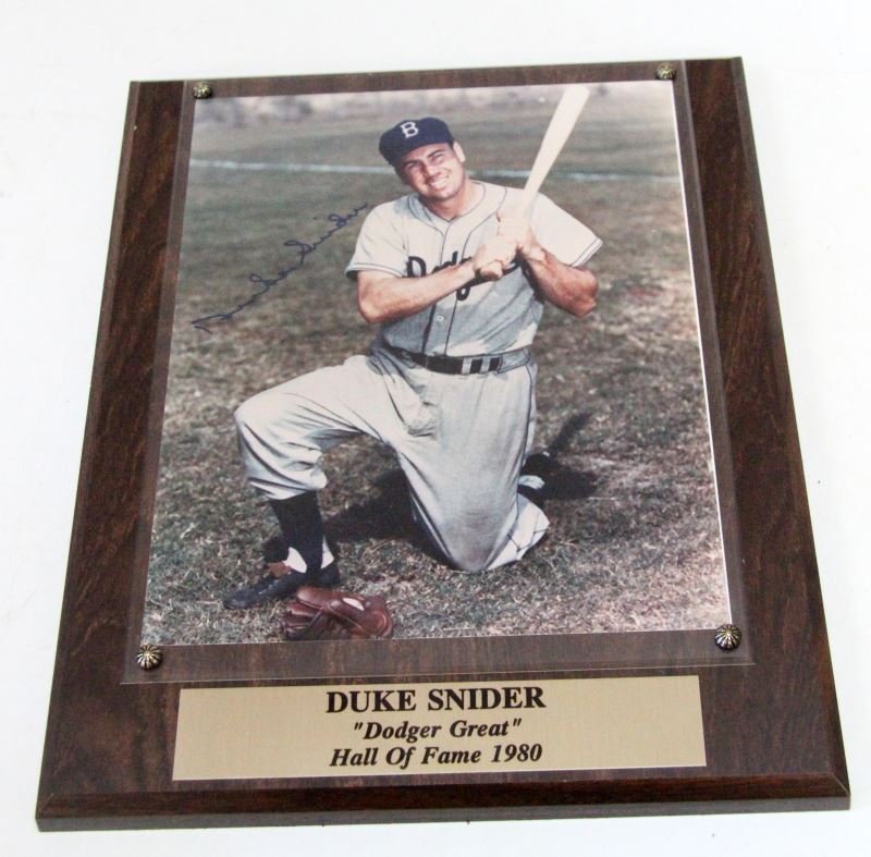 MOUNTED SIGNED PHOTO OF DUKE SNIDER WITH SOP COA: Color 8 by 10 photo of Duke Snider mounted to plaque and with plate reading "Duke Snider / Dodger Great / Hall of Fame 1980". Most likely from that time period. COA Sticker on back from "Stacks of Pla
