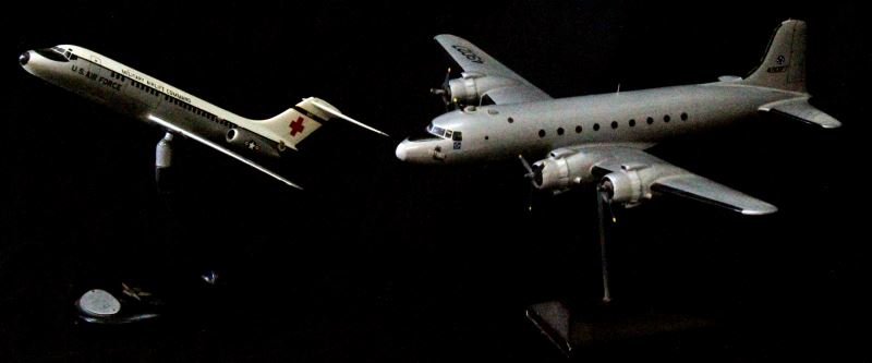 US AIRPLANE MODEL LOT OF TWO: Douglas C-54 Skymaster and Douglas DC-9 airplane models on stands. The Skymaster has a wingspan of 18 inches and is 15.5 inches long. It was two propellers missing. The DC-9 has a wingspan of 11 inche