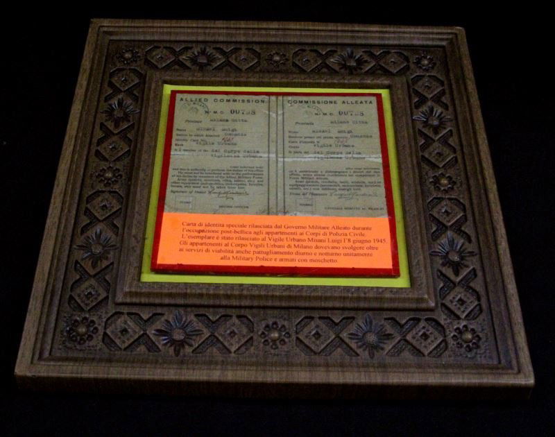 1945 LAMINATED ID PAPERS FOR MILAN URBAN POLICE: Formerly used as a display in the World Police Museum in Milan, Italy, this is a laminated and framed set of identification papers for a Milan officer in 1945. Attached to the item is a description in