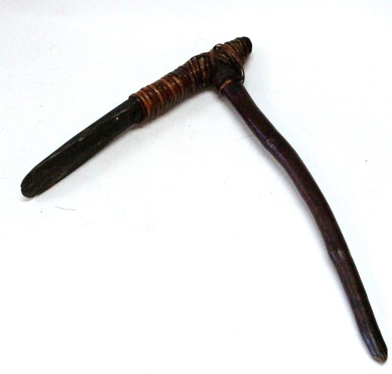 ANTIQUE AFRICA HAFTED STONE BLADE WAR CLUB: The blade can best be described as a stone Celt, hafted to wood shaft, use evidenced to the blade, measuring 17 by 21 inches.