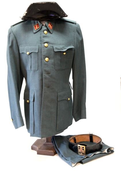 POST WWII SPAIN CIVIL GUARD UNIFORM W HAT & BELT: Circa 1960's uniform of the Spanish Civil Guard. The uniform consists of a tunic, trousers, belt and hat. The tunic includes a full set of buttons with insignia, and two enamel Civil Guard emblem coll