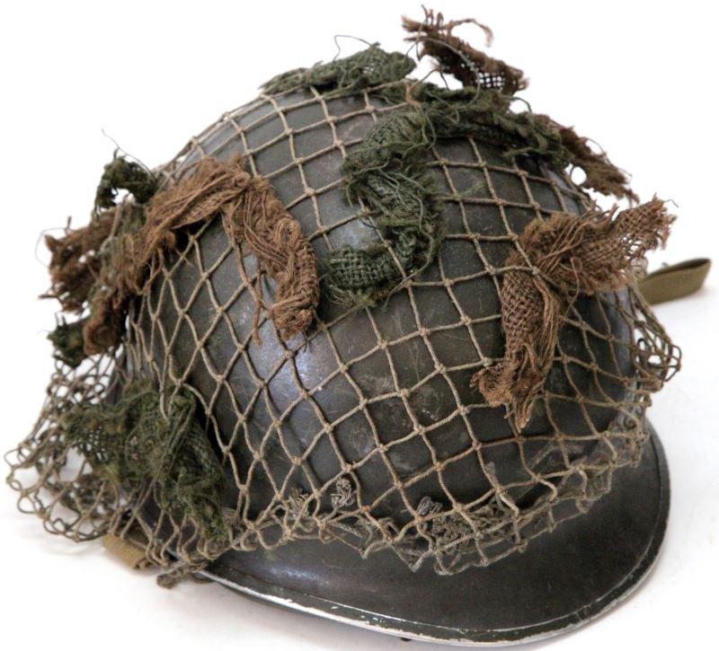 509 ARMY AIRBORNE DIVISION US WWII M1 HELMET: WWII M1 helmet for the 509 Airborne division. This helmet has a net and helmet lining. Helmet has chinstrap, lining and suspension. Has the 509 Airborne insignia painted on one side. Overall very good