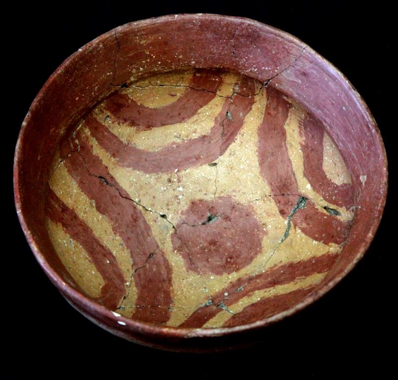 RED CLAY NATIVE AMERICAN SINAGUA BOWL PAINTED: Red clay bowl possibly by the Sinagua tribe. This bowl is made from a red clay that may be shell tempered. In red, the bowl has semicircular patterns painted. On the bottom, there are various black bu