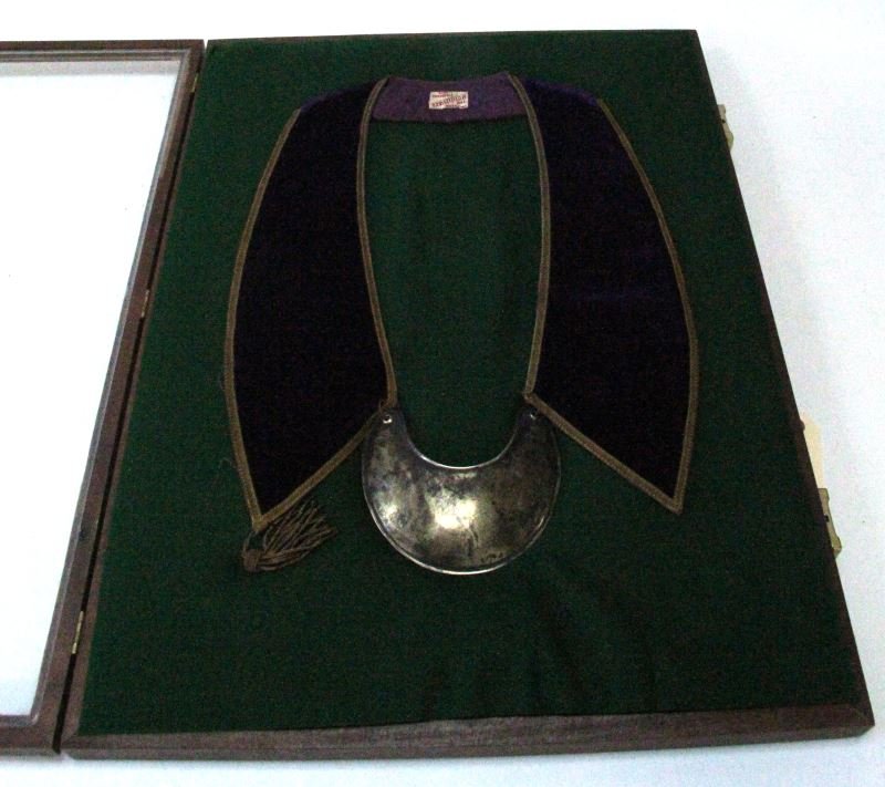 HUDSON BAY CEREMONIAL SASH WITH SILVER GORGET: Purple velvet sash with silver gorget made by the Hudson Bay Fur Trading Company. One side has a bullion tassel, it is unclear as to whether the other side would have had one. The item is in very good