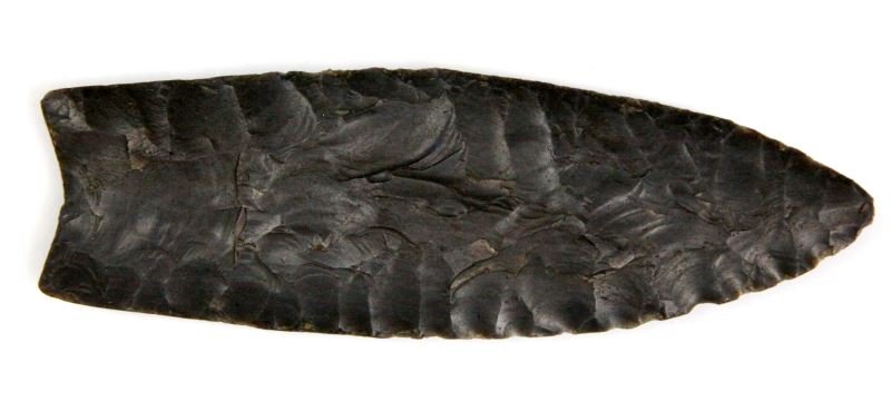5 INCH TENNESSEE CLOVIS PALEO ARROWHEAD POINT: Single flute basal ground, broad percussion flaking, wear patina as well as debitage, from the Appalachian Primitive Museum, Heflin, Alabama and acquire 1984.