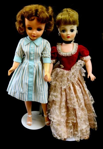 2 VINTAGE VINYL DOLLS IDEAL VT20 AND HORSMAN 83: 2 vintage dolls. Ideal VT-20 (Miss Revlon) has blue eyes, red lipstick and nails, wearing stockings, heels, bloomers, and striped dress, with stand. Horsman 83 has hair in a bun, vintage felt and lace