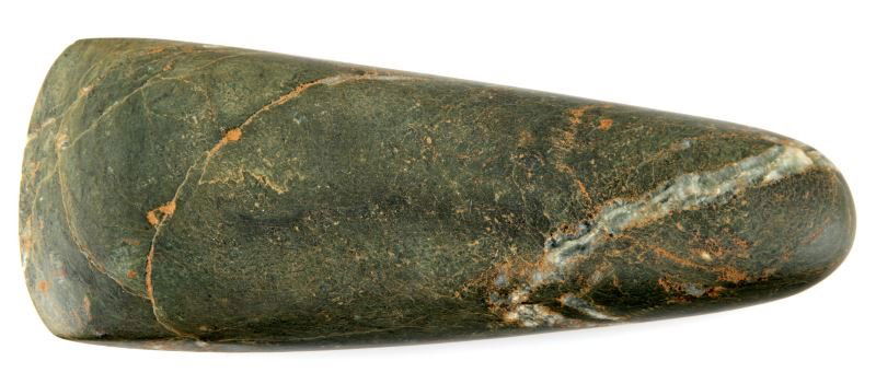 NATIVE AMERICAN POLISHED GREEN STONE CELT 7.5": Native American green stone celt measuring 7.5 inches long. The green stone has veins revealing quartz. There is debitage within the natural cracks of the stone. Late Archaic to Woodland period. Overa