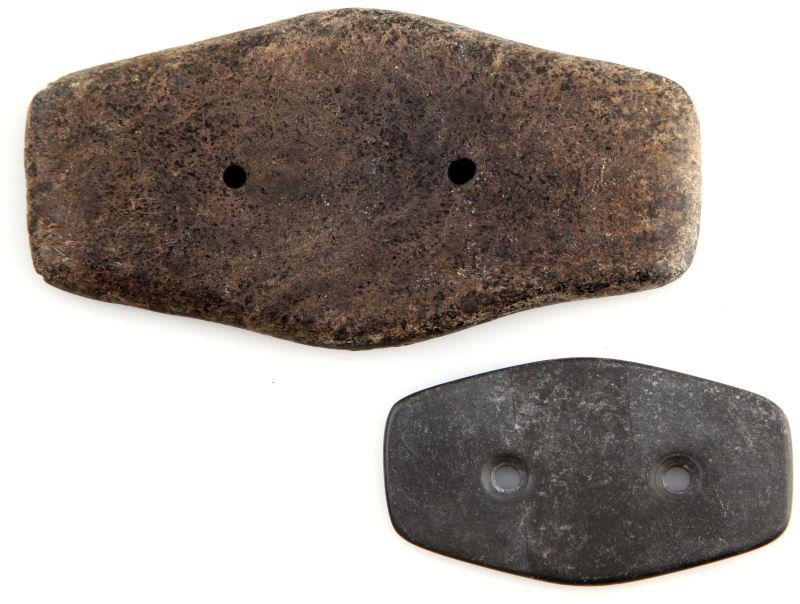 2 NATIVE AMERICAN DRILLED SLATE GORGET OHIO: 2 Native American drilled slate gorgets. One measures 2.5 inches long, charcoal color, smooth surface, with 2 holes. One measures 4.25 inches, with speckled patina and scratches from use, 2 holes, tag