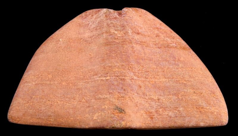 PIPESTONE WINGED BANNER STONE NATIVE AMERICAN PINK: Native American winged banner stone, made of pink pipestone. Banded, with chalky appearance. Measures 3.5 inches long. Small chip loss to one hole. Otherwise, very good. From private collector.