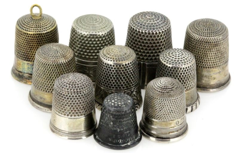 TEN ANTIQUE THIMBLES SIMON BROS AND MORE: Antique thimbles in an assortment of sizes, patterns, makers and metals. Some are unmarked while others were made by the Simon brothers, Ketcham & McDougall, and more. Some are marked sterling, one is