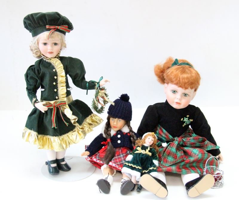 LOT OF WINTER DOLLS VARIOUS SIZES AND MAKERS: Lot of our dolls dressed in winter and holiday clothes. Included in this lot is n Effanbee doll and a doll marked K&S. There is a small Christmas porcelain doll measuring 6.5 inches. The tallest doll 