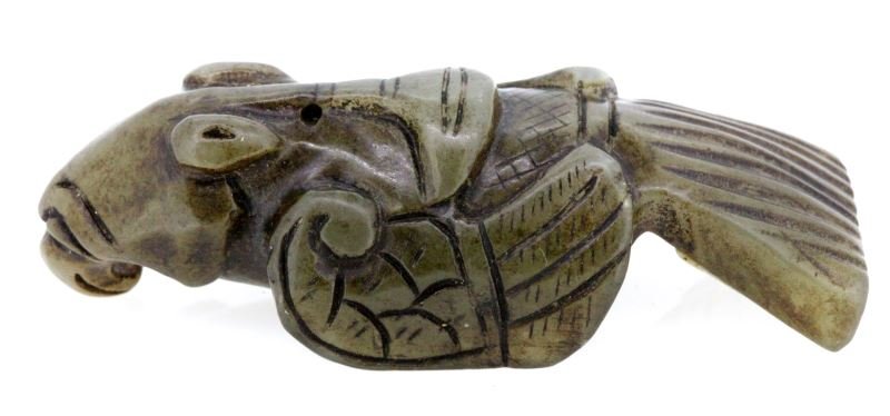 CARVED JADE BIRD POSSIBLY ZHOU DYNASTY: 3 inch long carved jade bird, possibly from the Western Zhou Dynasty. Has two small perforations on the back, possibly used as a pendant. Ornately carved. Very good condition 0
