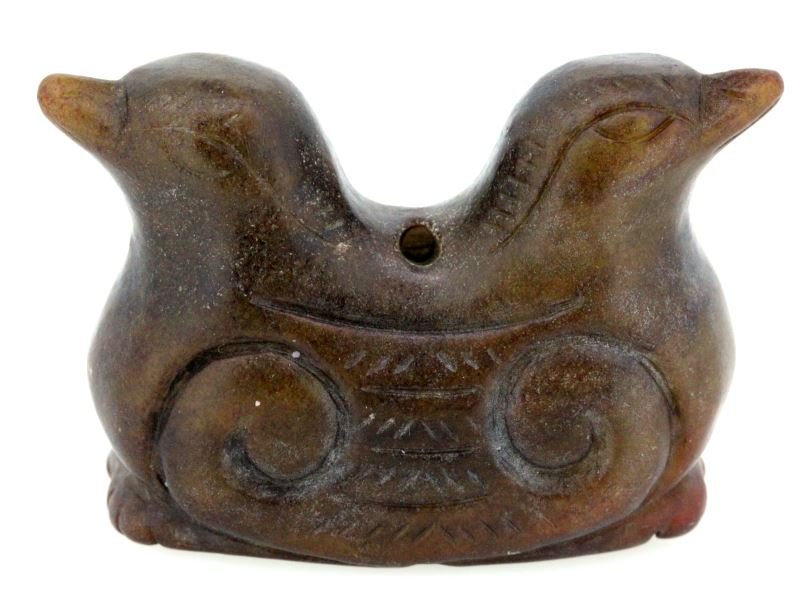 CARVED BROWN JADE DOUBLE HEADED BIRD ANTIQUE: Antique carved brown jade double headed bird, possibly from the Han Dynasty. 2 inches wide by 1.75 inches tall. Has two holes at the center, possibly used as a pendant. Carved with natural and geometr