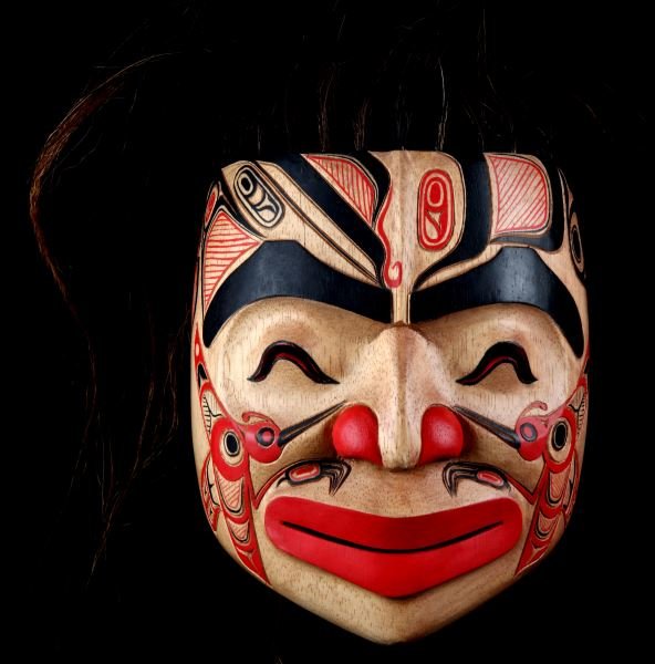 20TH CENTURY HAIDA NORTHWESTERN NATIVE MASK: Vintage Northwestern Pacific native mask. Made by the Haida tribe. The mask is carved, painted and has real hair. The makings on the mask depict geometric and figural decorations. This item was not us