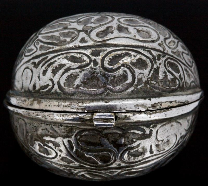 VICTORIAN WALNUT COMPACT PENDANT GERMAN: Small silver plated Victorian compact. The "walnut" measures 1.5 inches by 1.5 inches. The item opens and reveals a satin lined compartment and a small frame. The small frame can be lifted, creating a