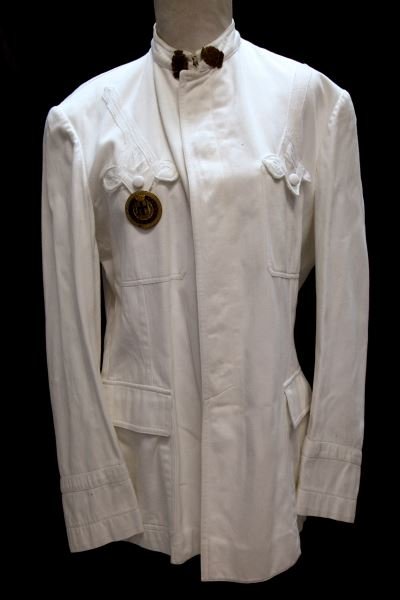 POST WAR MILAN URBAN POLICE UNIFORM W TRUNCHEON: Post World War II white Milan urban police uniform. The uniform consists of a tunic, trousers, shoes and truncheon. The uniform is free from mothing. The tunic has a complete set of buttons, collar em
