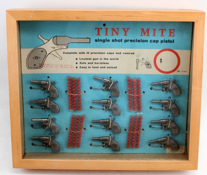 TINY MITE SINGLE SHOT PRECISION CAP PISTOL DISPLAY: Set of Tiny Mite single shot precision cap pistols in a display case. Twelve tiny pistols. The "loudest gun in the world." Overall very good condition.