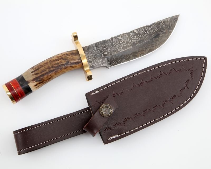 9 INCH DAMASCUS HUNTING KNIFE W STAG HORN & BRASS: 9 inch Ladder pattern Damascus steel hunting knife. Stag horn handle is capped off with uniquely cut brass hilt, and black and red layers of wood. Genuine leather sheath included. Handmade in Virginia