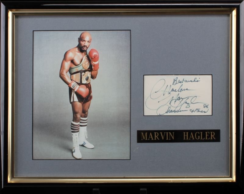 FRAMED MARVIN HAGLER PHOTO AND AUTOGRAPH: Framed Marvin Hagler autograph from 1986. The autograph is accompanied by a photograph of him. He was the Undisputed World Middleweight Champion from 1980 to 1987. 14 inches by 18 inches. Very good co