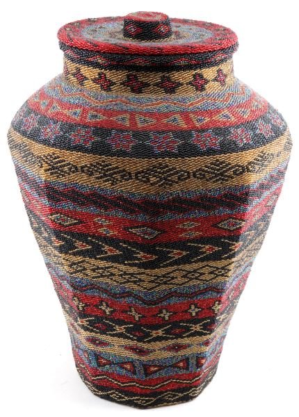 PAIUTE NATIVE AMERICAN BEADED BASKET LIDDED 21": Handcrafted Native American beaded basket, possibly made by the Paiute tribe. The basket has bands of red, black, gold and blue floral and geometric patterns. Measures 21 inches tall with a 9 inch rim
