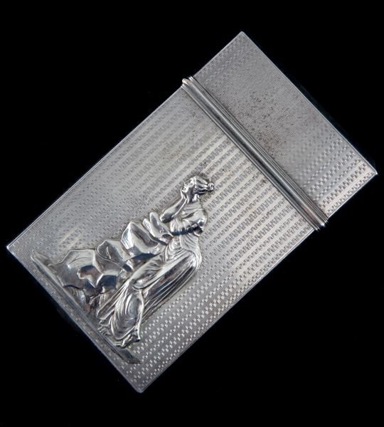 TAYLOR BALDWIN & CO SILVER CARD CASE ANTIQUE: Antique Taylor Baldwin & Co silver card case. The card case has a geometric engraved allover pattern. Each side has a plaque with a classical Greek female figure. The top is inscribed "MHB to Jane". V