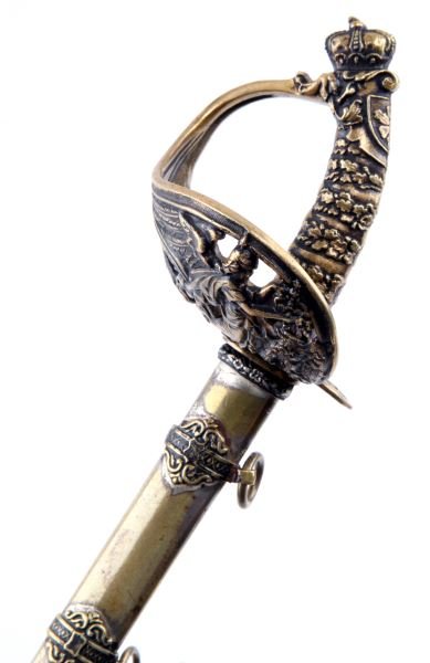 FRANZ JOSEPH MINIATURE PRESENTATION SWORD: Miniature presentation sword very similar to Kaiser Wilhelm's presentation sword. The blade is inscribed in German. The ricasso is inscribed with "P.A.H". The scabbard has wear on the metal finish. 12