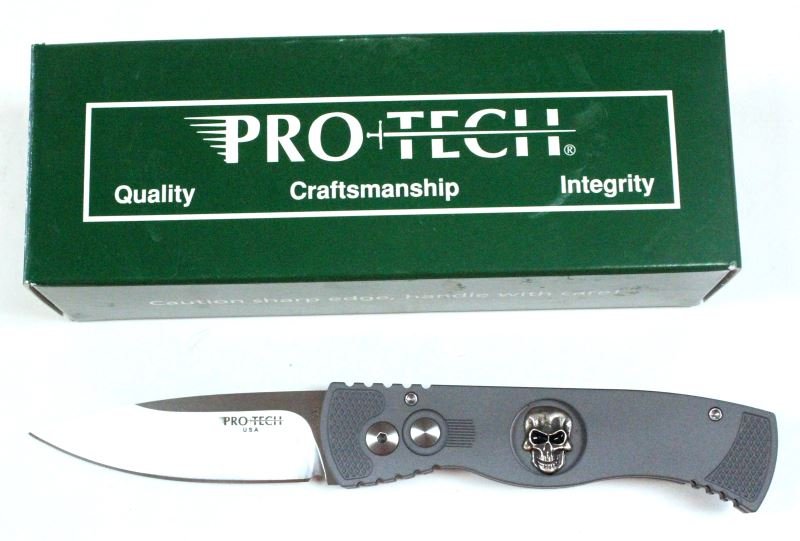 PROTECH TR-2.63 SKULL # 2 AUTOMATIC KNIFE: Protech tactical response automatic knife. Grey aluminum handle, sterling silver skull, satin finished blade. 254 out of 500. Comes with original packaging. 3 inch blade. Measures 4.25 inches when clo