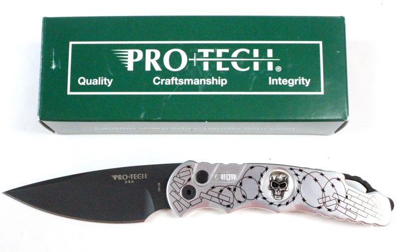 PROTECH TR-4.62 SKULL #2 AUTOMATIC TACTICAL KNIFE: Protech automatic tactical knife, model TR-4.62 Skull #2. Polished Aluminum handle with brick and barbed wire graphics. Sterling silver skull. Has a safety switch. Black blade and all black hardware. 